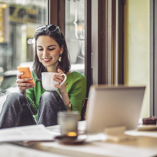 Young woman enjoying a cup of coffee on a rainy day